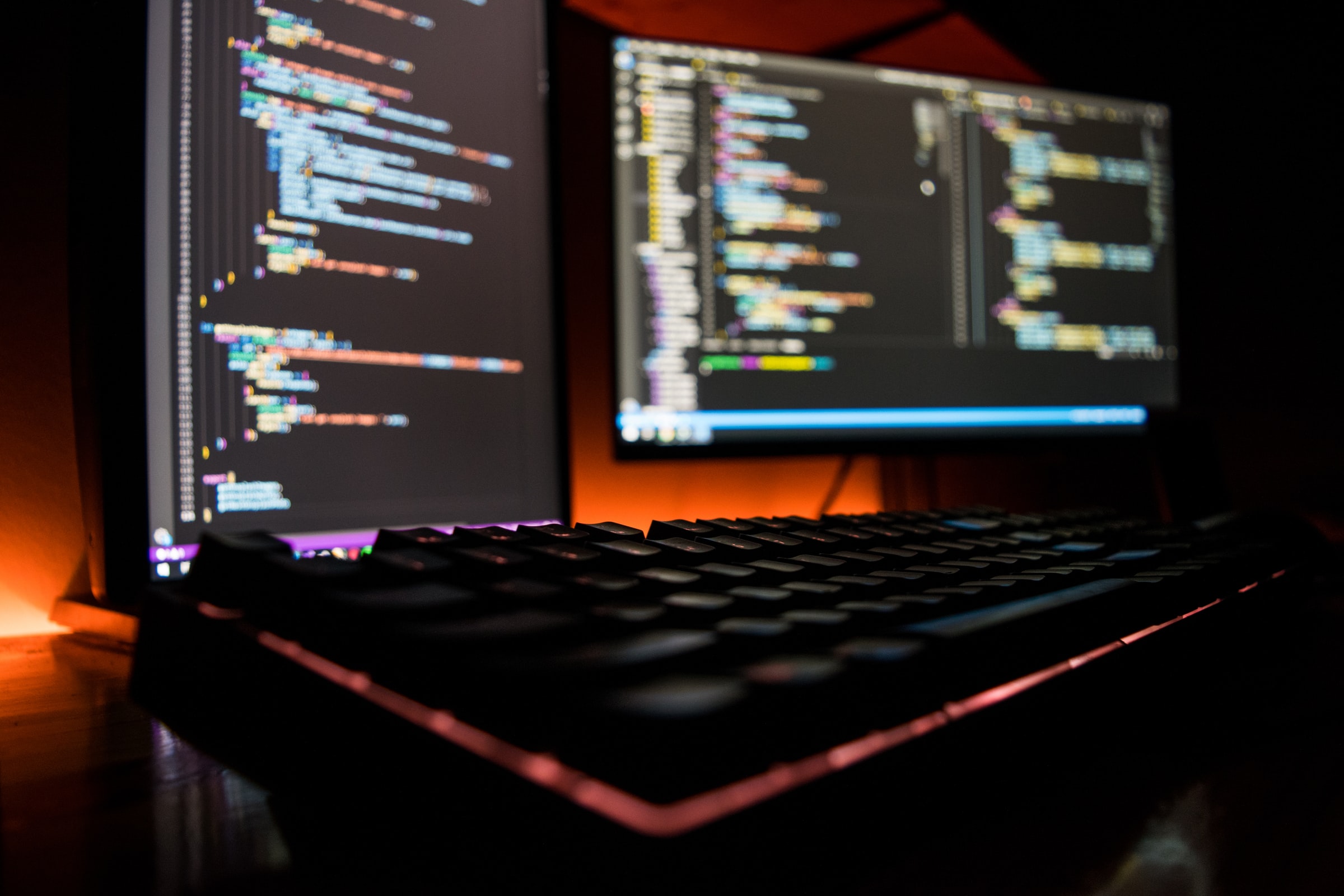 two screens showing code, out of focus