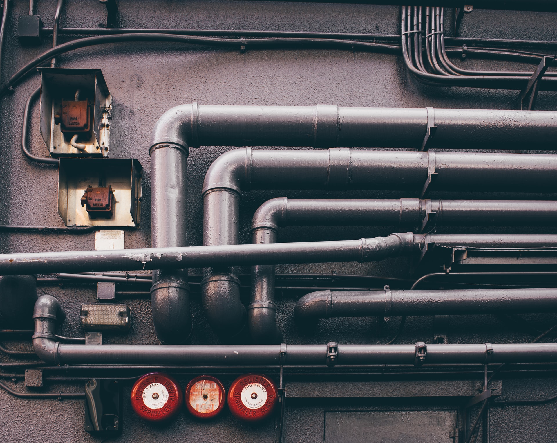 An image of several horizontal pipes, mostly parallel